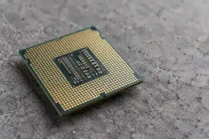 Voor deze afbeelding kies ik een close-up van een chip (microchip) die op een stevige, ruwe ondergrond ligt. Dit symboliseert de kwetsbaarheid van de chipsector en de noodzaak om steun te vinden op dit cruciale kruispunt. De chip is het hoofdonderwerp, terwijl de ondergrond de stabiliteit of instabiliteit van de index vertegenwoordigt.